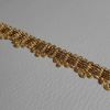 Imagen de Agreman dorado 4 tirillas H. 1 cm hilo metálico y viscosa para vestimenta 
