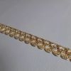 Imagen de Agreman dorado Flor de lis H. 1,2 cm hilo metálico y viscosa